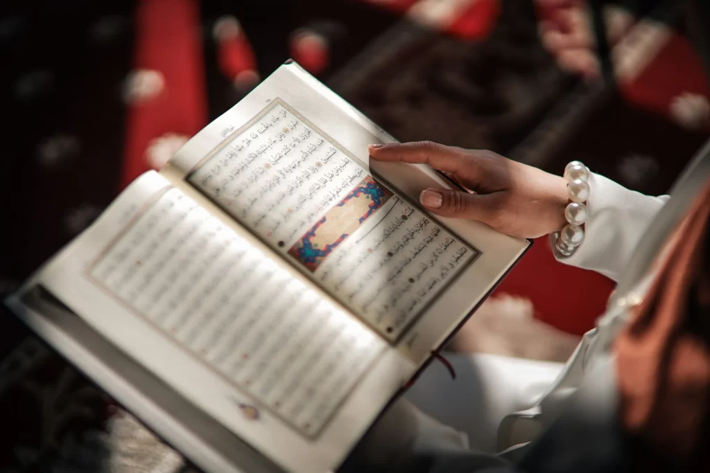Child revising Quran lessons at home with parent support