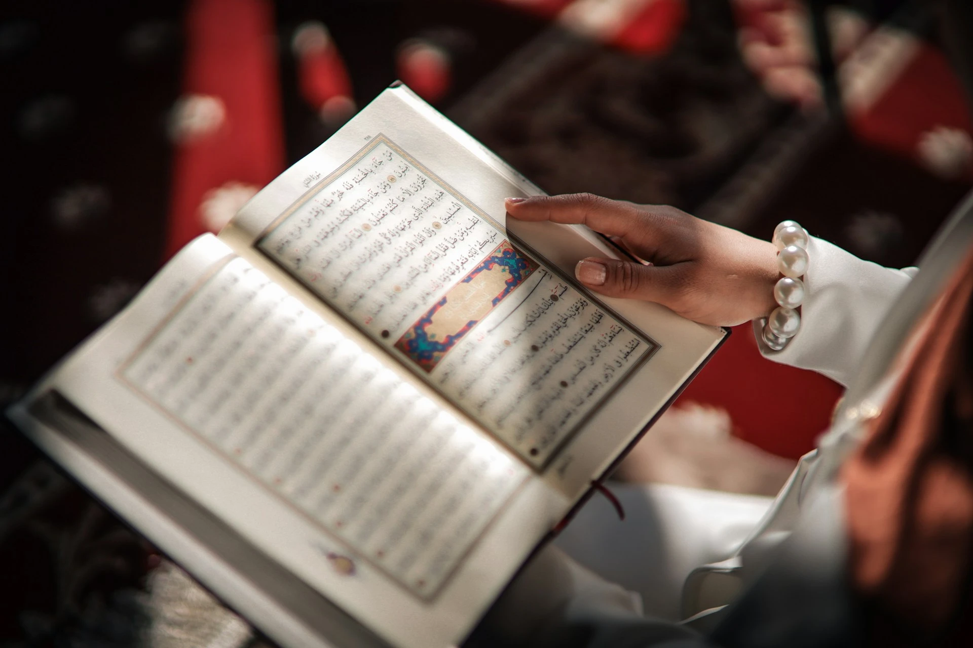 Child revising Quran lessons at home with parent support