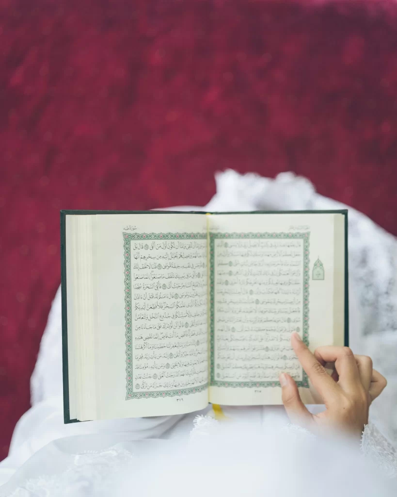 Child and sister reading the Quran at home, building consistency in daily Quran recitation